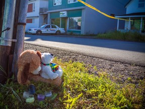 A memorial sits outside the Reptile Ocean exotic pet store in Campbellton, N.B., on Tuesday, August 6, 2013. The owner of a New Brunswick exotic pet store that housed an African rock python that escaped and strangled two young boys says he is in shock. (THE CANADIAN PRESS/John LeBlanc)