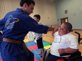 Little Ninja Sammy Uprichard, right, shows martial arts instructor Mark Gasparovic defensive moves during Kids Beating Cancer Honourable Little Ninja Martial Arts Class at John McGivney Centre. (NICK BRANCACCIO / The Windsor Star)