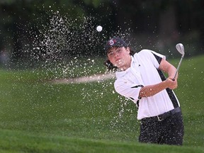 Riley Fry hits a bunker shot Monday, Aug.12, 2013, during the Jamieson Junior Golf Tour event at the Pointe West Golf Club in Amherstburg. (DAN JANISSE/The Windsor Star)