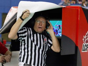 Head referee Jake Ireland pokes his head out from under the hood at the instant replay booth during a CFL game in 2006. The retired CFL official was working the Ravens game in Essex Saturday. (John Mahoney/The Gazette)