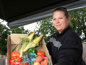 In this file photo, Nicole Beaudoin displays some of the produce for sale Friday, Aug. 2, 2013, at her stand at the Olde Sandwich Towne Farmers' Market in Windsor, Ont. (DAN JANISSE/The Windsor Star)