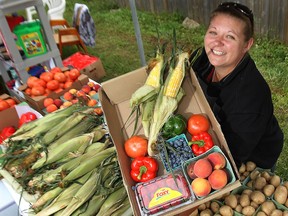 In this file photo, Nicole Beaudoin displays some of the produce for sale Friday, Aug. 2, 2013, at her stand at the Olde Sandwich Towne Farmers' Market in Windsor, Ont. (DAN JANISSE/The Windsor Star)