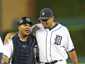 Brayan Pena, left, and Joaquin Benoit celebrate a win over the Kansas City Royals at Comerica Park on August 15, 2013 in Detroit, Michigan. The Tigers defeated the Royals 4-1. (Photo by Leon Halip/Getty Images)