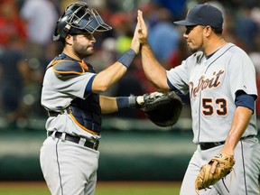 Detroit catcher Alex Avila, left, celebrates with closing pitcher Joaquin Benoit after the Tigers defeated the Cleveland Indians at Progressive Field on August 5, 2013 in Cleveland. (Photo by Jason Miller/Getty Images)