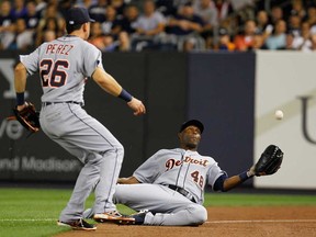 Detroit's Torii Hunter, right, makes a sliding catch against the New York Yankees as Hernan Perez looks on at Yankee Stadium on August 9, 2013 in the Bronx borough of New York City.  (Photo by Mike Stobe/Getty Images)