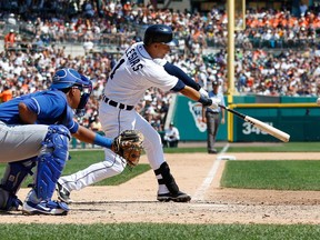 Detroit's Jose Iglesias, right, hits a base hit in front of Salvador Perez of the Kansas City Royals at Comerica Park on August 18, 2013 in Detroit. Detroit won the game 6-3. (Gregory Shamus/Getty Images)