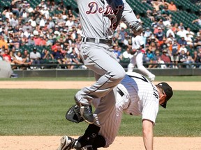 Tigers outfielder Austin Jackson, left, reaches first on a throwing error against White Sox first baseman Jeff Keppinger during the sixth inning Wednesday, Aug. 14, 2013, in Chicago. Matt Tuiasosopo and Omar Infante scored on the play. (AP Photo/Charles Rex Arbogast)