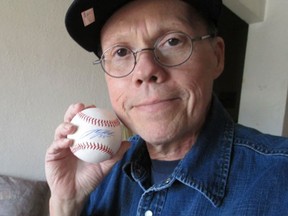 Windsor-born Tim Simpson holds the autographed baseball he was given by the Detroit Tigers in this 2013 file photo. (Handout / The Windsor Star)