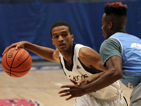 Khalid Abdel-Gabar, left, of the Windsor Lancers dribbles in front of Southern University's Tre'lun Banks during the OUA/NCAA Tip-Off Classic at the St. Denis Centre August 14, 2013. (NICK BRANCACCIO-The Windsor Star)