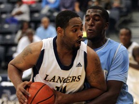 Bradford Parker, left, of the WIndsor Lancers makes a play against Southern University's Javan Mitchell during the OUA/NCAA Tip-Off Classic at the St. Denis Centre August 14, 2013. (NICK BRANCACCIO-The Windsor Star)