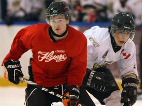 Leamington's Cale Allen, left, keeps position in front of LaSalle's Nick Crescenzi in first period Junior B exhibition action from Vollmer Centre August 21, 2013. The Vipers and Leamington played to a 4-4 tie. (NICK BRANCACCIO/The Windsor Star)