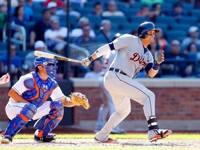 Detroit's Victor Martinez, right, follows through on an RBI base hit against the New York Mets at Citi Field on August 25, 2013 in New York.  (Photo by Jim McIsaac/Getty Images)