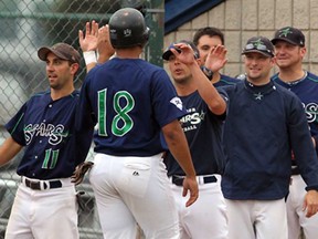 Matt Cook of the Windsor Stars is congratulated by Jason Chapieski, left, Mike Czerwieniec and other teammates after scoring Stars' second run against Alberta 2 during the Canadian Senior Baseball Championships at Cullen Field Tuesday August 22, 2013. (NICK BRANCACCIO/The Windsor Star)