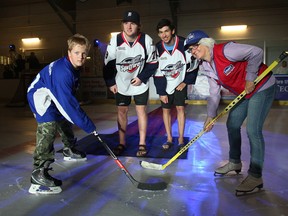 Lowe's Canada unveiled the newly upgraded Forest Glade rink Saturday, Sept. 21, 2013, in Windsor.  Lowe's donated $50,000 to the projrct as part of the community rink renovation program. The official party included a puck drop between Tanner Grass, 11, and local Lowe's employee Debbie Pursel. Dropping the puck were Windsor Spitfire players Ty Bilcke, left, and Jordan DeKort.  (DAN JANISSE/The Windsor Star)