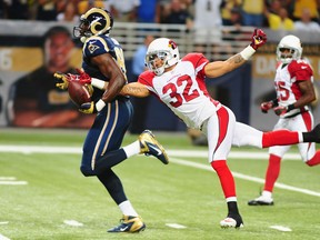 Safety Tyrann Mathieu #32 of the Arizona Cardinals strips the ball from tight end Jared Cook #89 of the St. Louis Rams at the Edward Jones Dome on September 8, 2013 in St. Louis, Missouri.  (Photo by Michael Thomas/Getty Images)