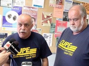 CUPE Local 1001 president Dave Montgomery, left, and CUPE Local 1393 president Dean Roy talk to the media after CUPE Local 1001voted to ratify a tentative deal at the University of Windsor Sunday, September 22, 2013. (JOEL BOYCE/The Windsor Star)