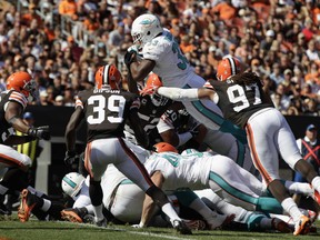 Running back Daniel Thomas #33 of the Miami Dolphins scores a touchdown in front of defenders Tashaun Gipson #29 and Jabaal Sheard #97 of the Cleveland Browns at Cleveland Browns Stadium on September 8, 2013 in Cleveland, Ohio. (Photo by Matt Sullivan/Getty Images)