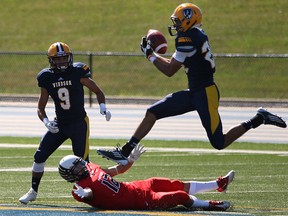Windsor's defensive back, Louis Polyzois, right, makes an interception during the third quarter of OUA football action at Alumni Field between the Windsor Lancers and the Carleton Ravens, Saturday, Sept. 14, 2013.  (DAX MELMER/The Windsor Star)