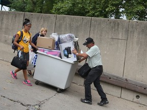 Volunteers help students move into residences at the University of Windsor, Sunday, Sept. 1, 2013.  (DAX MELMER/The Windsor Star)