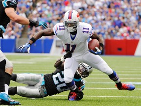 Buffalo Bills wide receiver T.J. Graham (11) is tackled by Carolina Panthers cornerback D.J. Moore in the third quarter of an NFL football game Sunday, Sept. 15, 2013, in Orchard Park, N.Y. (AP Photo/Gary Wiepert)