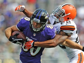 Cleveland Browns cornerback Buster Skrine, right, wraps up Baltimore Ravens tight end Dennis Pitta during the second half of an NFL football game in Baltimore, Md., Sunday, Sept. 15, 2013. (AP Photo/Gail Burton)