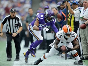 Josh Robinson #21 of the Minnesota Vikings forces Davone Bess #15 of the Cleveland Browns out of bounds during the second quarter of the game on September 22, 2013 at Mall of America Field at the Hubert H. Humphrey Metrodome in Minneapolis, Minnesota. (Photo by Hannah Foslien/Getty Images)