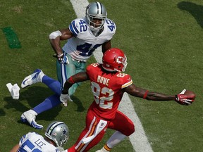 Kansas City Chiefs wide receiver Dwayne Bowe (82) crosses the goal line between Dallas Cowboys free safety Barry Church (42) and middle linebacker Sean Lee (50) to score a touchdown during the second half of an NFL football game at Arrowhead Stadium in Kansas City, Mo., Sunday, Sept. 15, 2013. (AP Photo/Charlie Riedel)