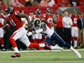 Julio Jones #11 of the Atlanta Falcons scores a touchdown after breaking a tackle by Janoris Jenkins #21 of the St. Louis Rams at Georgia Dome on September 15, 2013 in Atlanta, Georgia.  (Photo by Kevin C. Cox/Getty Images)