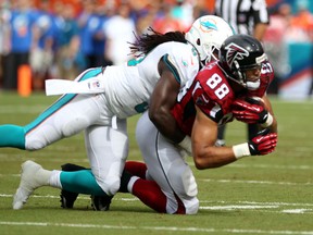 Tight End Tony Gonzalez #88 of the Atlanta Falcons is brought down by Linebacker Philip Wheeler #52 of the Miami Dolphins at Sun Life Stadium on September 22, 2013 in Miami Gardens, Florida.  (Photo by Marc Serota/Getty Images)