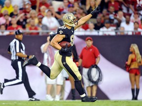 New Orleans Saints tight end Jimmy Graham (80) celebrates as he scores on a 56-yard touchdown reception from quarterback Drew Brees against the Tampa Bay Buccaneers during the first quarter of an NFL football game on Sunday, Sept. 15, 2013, in Tampa, Fla. (AP Photo/Brian Blanco)