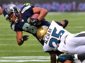 Cornerback Demetrius McCray #35 of the Jacksonville Jaguars tackles wide receiver Golden Tate #81 of the Seattle Seahawks during the second quarter of the game at CenturyLink Field on September 22, 2013 in Seattle, Washington. (Steve Dykes / Getty Images)