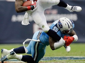 Houston Texans' Ben Tate (44) is stopped by Tennessee Titans' Zach Brown (55) during the second quarter of an NFL football game on Sunday, Sept. 15, 2013, in Houston. (AP Photo/David J. Phillip)