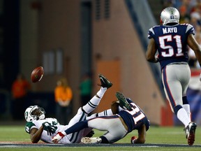 Wide receiver Stephen Hill #84 of the New York Jets fumbles in the first quarter as he is hit by cornerback Aqib Talib #31 of the New England Patriots at Gillette Stadium on September 12, 2013 in Foxboro, Massachusetts. The patriots recovered the fumble.  (Photo by Jared Wickerham/Getty Images)