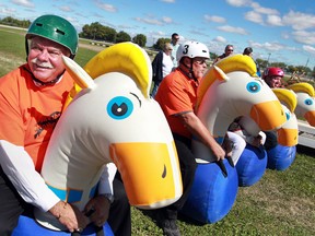 Windsor-Tecumseh MPP Percy Hatfield, left, and Larry Verbeke, centre, town councillor for Leamington, prepare to race their fellow elected officials, Tom Bain, Essex County Warden, (not pictured) and Taras Natyshak, MPP for Essex, on a bouncy horse during harness racing at the Leamington Fairgrounds, Sunday, Sept. 22, 2013.  Sunday was the first of four harness racing dates at the Leamington Fairgrounds.  (DAX MELMER/The Windsor Star)