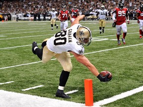 New Orleans Saints tight end Jimmy Graham (80) reaches over the pylon to score a touchdown on a pass play in the second half of an NFL football game against the Atlanta Falcons in New Orleans, Sunday, Sept. 8, 2013. (AP Photo/Bill Feig)