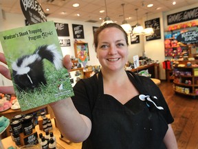 Deanna Morris, store manager at Lush Cosmetics at the Devonshire Mall in Windsor, displays a postcard that protests the city of Windsor's skunk trapping policy. The company is encouraging customers to sign the postcards which will then be sent to the city.  (DAN JANISSE/The Windsor Star)