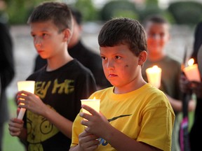 Michael Siwak holds a candle at the 2012 Take Back The Night march, an annual stand against violence toward women, at Dieppe Park Saturday Sept. 29, 2012 in Windsor.  (Windsor Star files)