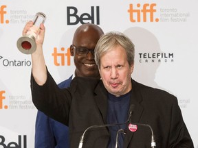 Alan Zweig accepts the award for Best Canadian Feature Film for his film "When Jews Were Funny" as Tiff's Artistic Director Cameron Bailey, rear, looks on during the 2013 Toronto International Film Festival in Toronto on Sunday Sept. 15, 2013. THE CANADIAN PRESS/Chris Young