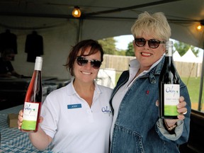 Master taster Jody Goslin and Stephanie Smith hold up wine bottles at the Oxley Estate Winery booth at the Shores of Erie International Wine Festival Sunday, Sept. 8, 2013 at Fort Malden in Amherstburg. Oxley Estate Winery were one of the three new vendors at the festival this year. (JOEL BOYCE/The Windsor Star)