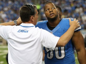 Detroit Lions head coach Jim Schwartz, left, talks with Ndamukong Suh on the sidelines during the second quarter against the Minnesota Vikings at Ford Field Sunday. (Photo by Leon Halip/Getty Images)