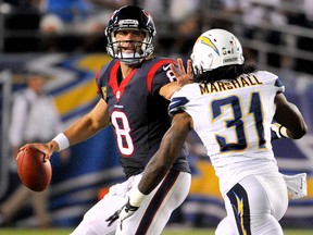 Houston Texans quarterback Matt Schaub, left, throws under pressure by San Diego Chargers defensive back Richard Marshall during the second half Monday in San Diego. (AP Photo/Denis Poroy)