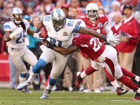 Detroit's Calvin Johnson, left, is tackled by Arizona's William Gay at the University of Phoenix Stadium in 2012. The Cardinals beat the Lions 25-21. (Christian Petersen/Getty)