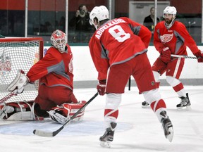 Detroit's Justin Aabdelkader, centre, scores a goal against goaltender Tom McCollum during training camp Friday in Traverse City. (AP Photo/John L. Russell)