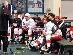 Red Wings associate coach Tom Renney, left, talks to players during training camp Friday in Traverse City. (AP Photo/John L. Russell)