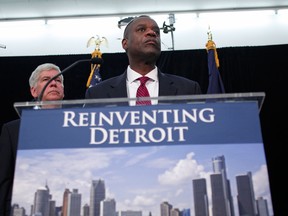 In this file photo, Detroit emergency manager Kevin Orr (C) and Michigan Gov. Rick Snyder (L) address Detroit's bankruptcy filing at a news conference July 19, 2013 in Detroit, Michigan. Orr made the Chapter 9 filing yesterday. Detroit owes its approximately 100,000 creditors between $18 and $20 billion. (Bill Pugliano/Getty Images)