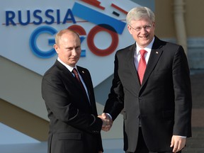 Russian President Vladimir Putin, left, and Canadian Prime Minister Stephen Harper shake hands during an official welcome at the G20 summit on September 5, 2013 in St. Petersburg, Russia. (Ramil Sitdikov/Host Photo Agency via Getty Images)