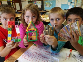 Accomplished mathematics students Elijah Olson, left, Zara Coulter, Piers Johnston and Jamie Gagnon from Queen Victoria Public School, uses a variety of "manipulatives" to help them "see the math" during class Wednesday September 18, 2013. The Toronto School Board's strikingly ambitious plan to improve student achievement is one local boards should match.  (Windsor Star files)