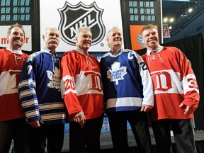 Retired Toronto Maple Leafs players, from left, Wendell Clark, Lanny McDonald and Darryl Sittler stand with retired Detroit Red Wings players, from left, Joey Kocur, Mickey Redmond and Kris Draper. (AP Photo/Detroit News, David Guralnick)