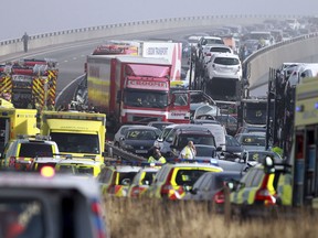 Emergency vehicles attend the scene of a major accident on the Sheppey Bridge Crossing near Sheerness in Kent, south England, following a multi vehicle collision earlier this morning, Thursday Sept. 5, 2013. According to police at the scene around 100-vehicles are involved in the pile-up on a bridge in heavy fog, leaving at least eight people seriously injured after what witnesses described as ''carnage". (AP Photo/Gareth Fuller, PA)