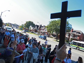 Approximately 50 people protest the removal of a large steel cross from Hotel-Dieu Grace Hospital on Ouellette Ave., Friday, Sept. 27, 2013. The cross is being transferred to the Tayfour Campus which will be named Hotel-Dieu Grace Healthcare. (DAX MELMER/The Windsor Star)